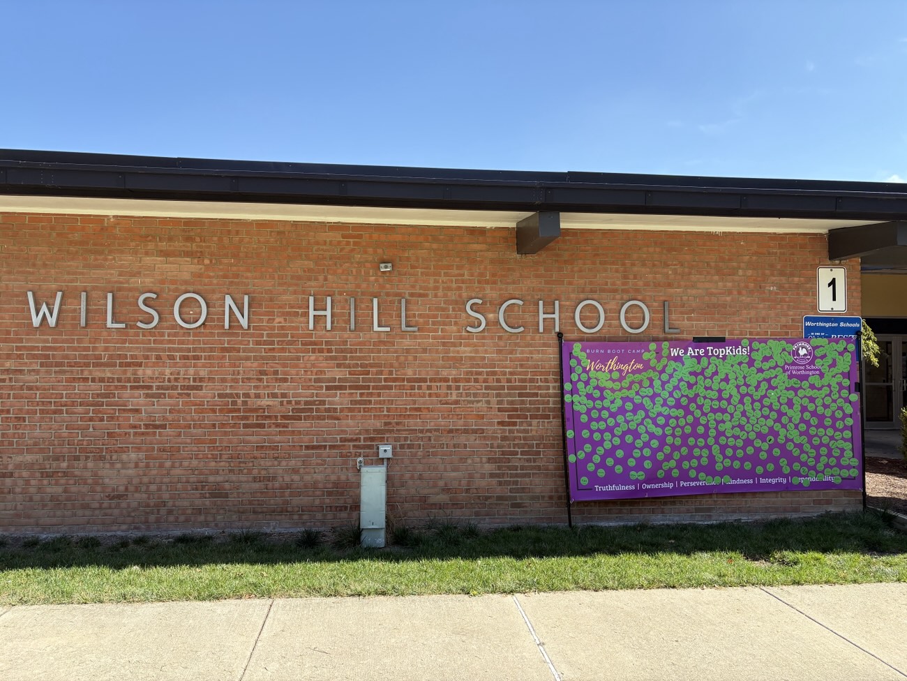 The We Are TopKids banner outside Wilson Hill School
